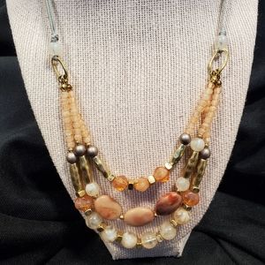 New, three drop necklace with peach, gold, and silver.